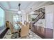 Elegant dining room with modern chandelier and view of the staircase at 14031 Jomatt Loop, Winter Garden, FL 34787