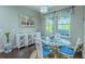 Bright dining room with hardwood floors, a modern table set, and a decorative cabinet at 14031 Jomatt Loop, Winter Garden, FL 34787