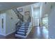 Grand two-story foyer with dark wood staircase, chandelier, and bright entryway at 14031 Jomatt Loop, Winter Garden, FL 34787