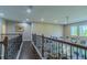 Upstairs hallway featuring dark hardwood floors, rod iron railing and views of the first floor at 14031 Jomatt Loop, Winter Garden, FL 34787