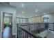 Second floor hallway with iron railings and entry to a bedroom at 14031 Jomatt Loop, Winter Garden, FL 34787