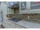 Kitchen details feature granite countertops and stainless steel appliances at 14031 Jomatt Loop, Winter Garden, FL 34787