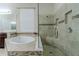 The main bathroom has a soaking tub, a frameless shower, and a double vanity at 14031 Jomatt Loop, Winter Garden, FL 34787