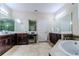 The main bathroom features a soaking tub, a frameless shower, and dual vanities at 14031 Jomatt Loop, Winter Garden, FL 34787