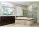 The main bathroom has a soaking tub, a frameless shower, and a double vanity at 14031 Jomatt Loop, Winter Garden, FL 34787