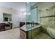 The main bathroom features a soaking tub, a frameless shower, and dual vanities at 14031 Jomatt Loop, Winter Garden, FL 34787