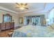 The main bedroom features hardwood floors, a ceiling fan, and an adjacent sitting area at 14031 Jomatt Loop, Winter Garden, FL 34787