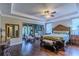 The main bedroom features hardwood floors, a ceiling fan, and an adjacent sitting area at 14031 Jomatt Loop, Winter Garden, FL 34787