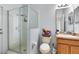 Bathroom featuring a glass-enclosed shower, toilet, and vanity with storage at 150 Magnolia Park Trl, Sanford, FL 32773