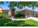 Charming single-story home featuring a well-manicured lawn and beautiful landscaping at 150 Magnolia Park Trl, Sanford, FL 32773