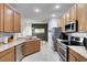 Spacious kitchen featuring stainless steel appliances and a breakfast bar at 150 Magnolia Park Trl, Sanford, FL 32773