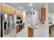 Well-lit kitchen with stainless steel appliances and ample cabinet space at 150 Magnolia Park Trl, Sanford, FL 32773