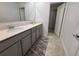 Modern bathroom with double sinks, quartz countertops, and a shower at 2006 Myrtle Pine St, Kissimmee, FL 34746