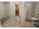 Bathroom featuring tile floor, a glass-enclosed shower, and a doorway to the bedroom at 2006 Myrtle Pine St, Kissimmee, FL 34746