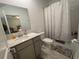 Simple bathroom with modern vanity, toilet, and shower with curtain at 2006 Myrtle Pine St, Kissimmee, FL 34746