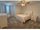 Bright bedroom with a white bed frame, matching nightstands and carpeted floors at 2006 Myrtle Pine St, Kissimmee, FL 34746