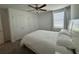 Cozy bedroom featuring a large bed, ceiling fan, and ample closet space at 2006 Myrtle Pine St, Kissimmee, FL 34746