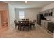 Open dining area features tile floors, a view into the kitchen, and a window for natural light at 2006 Myrtle Pine St, Kissimmee, FL 34746