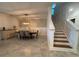 Dining room featuring a modern chandelier, an accent wall, and access to the staircase at 2006 Myrtle Pine St, Kissimmee, FL 34746