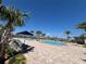 Resort-style community pool with lounge chairs and palm trees under a clear blue sky at 2006 Myrtle Pine St, Kissimmee, FL 34746