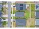 An aerial view shows neighboring rooftops and tree coverage in this quiet community at 207 Polermo Ave, St Cloud, FL 34771