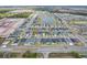 An aerial view showing a community neighborhood with homes surrounding a scenic lake and wetlands at 207 Polermo Ave, St Cloud, FL 34771