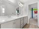 Stylish bathroom showcasing double vanity with gray cabinets, marble counters, and wood-look flooring at 207 Polermo Ave, St Cloud, FL 34771