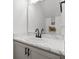 Bathroom featuring a single vanity with a white marble top, large mirror, and black hardware at 207 Polermo Ave, St Cloud, FL 34771