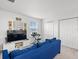 A bonus room featuring a blue sofa, TV, keyboard, and double door closet on a carpeted floor at 207 Polermo Ave, St Cloud, FL 34771