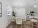 Bright dining area with a modern chandelier, and adjacent to the stylish kitchen and bar seating at 207 Polermo Ave, St Cloud, FL 34771