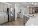 This is a spacious kitchen with stainless steel appliances, light gray cabinetry, and hard wood floors at 207 Polermo Ave, St Cloud, FL 34771