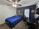 Cozy bedroom featuring blue accent wall, carpet flooring, and a ceiling fan at 2413 Sandridge Cir, Eustis, FL 32726