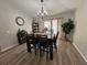 Bright dining room with a sliding glass door, wood floors, chandelier, and ample natural light at 2413 Sandridge Cir, Eustis, FL 32726