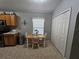 Cozy eat-in kitchen area with tile flooring, a window with natural light, and access to the main kitchen at 2413 Sandridge Cir, Eustis, FL 32726