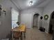 Bright breakfast nook featuring tile flooring, a window with a view, and access to main areas at 2413 Sandridge Cir, Eustis, FL 32726