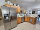 Functional kitchen featuring stainless steel appliances, tile flooring and ample counter space at 2413 Sandridge Cir, Eustis, FL 32726