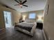 Relaxing main bedroom featuring wood floors, ceiling fan, and neutral walls creating a calm space at 2413 Sandridge Cir, Eustis, FL 32726