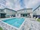 Inviting backyard pool with lounge chairs and interlocking brick patio, perfect for outdoor relaxation and entertaining at 273 Auburn Ave, Kissimmee, FL 34747