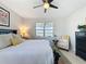 Charming bedroom with neutral tones, a ceiling fan, and a view of the outside from the windows at 2842 Purple Meadow Ct, Minneola, FL 34715