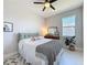 Calming bedroom with a patterned throw, houseplant and a ceiling fan above the bed at 2842 Purple Meadow Ct, Minneola, FL 34715