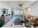 Comfortable living room featuring a ceiling fan, decorative rug, and sliding doors to the balcony with views at 2842 Purple Meadow Ct, Minneola, FL 34715