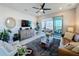 Bright living room with stylish furniture, ceiling fan, and sliding doors to the balcony with views at 2842 Purple Meadow Ct, Minneola, FL 34715