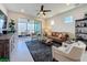 Inviting living room with a brown leather couch and a sliding door leading to a beautiful outdoor view at 2842 Purple Meadow Ct, Minneola, FL 34715