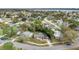 Aerial view of a home nestled in a lush neighborhood with nearby lake access at 3107 Martinique Way, Orlando, FL 32805