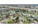 An aerial view of a neighborhood showcasing many homes with mature trees and community pool at 3107 Martinique Way, Orlando, FL 32805