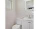 Cozy bathroom with white toilet, vanity, and wall tiles at 3107 Martinique Way, Orlando, FL 32805