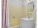 Cozy bathroom with yellow tiles and a shower with curtain at 3107 Martinique Way, Orlando, FL 32805