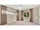 Spacious bedroom featuring neutral carpet, ceiling fan, and curtain-covered windows at 3107 Martinique Way, Orlando, FL 32805