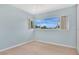 Bright bedroom featuring neutral carpet, and large window with a view at 3107 Martinique Way, Orlando, FL 32805