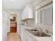 Bright kitchen with white cabinets, stainless sink, and natural light coming through the window at 3107 Martinique Way, Orlando, FL 32805